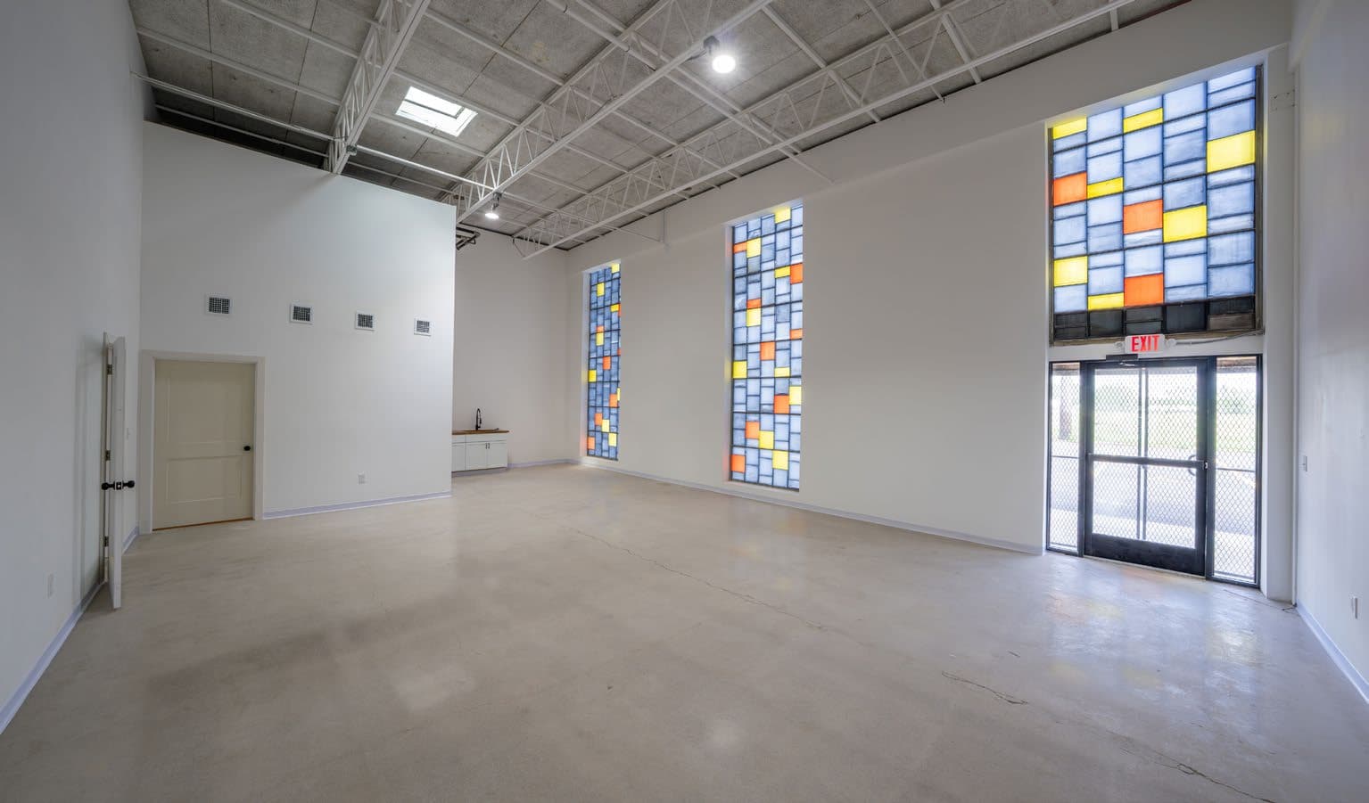 Polished concrete floor along accent glass block wall and entry door
